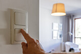 Fototapeta Do pokoju - Saving energy at home, turning off the light
