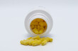 Pills in yellow color with pills can on white background, medicine, cropped image