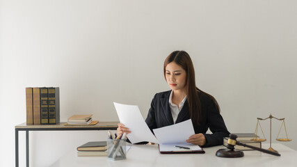 Law concept, Female lawyer is reading contract about legal regulations and working in law firm