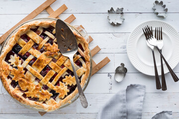 Wall Mural - A fresh baked lattice cherry pie with pie server and plates, ready for serving.