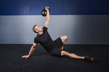 man performs a kettlebell turkish get up