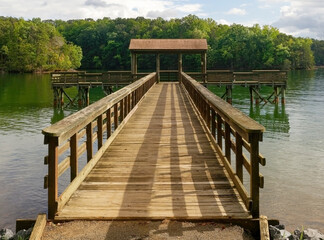 Wall Mural - Empty fishing pier on mountain lake.