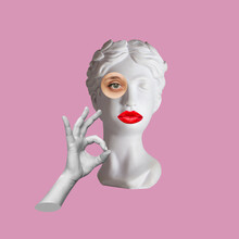 Antique Female Statue's Head With Red Lips Shows The Ok Gesture With Hand Isolated On A Pink Color Background. 3d Trendy Abstact Collage In Magazine Surreal Style. 3d Contemporary Art. Modern Design
