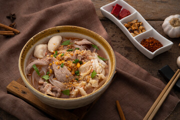 Noodles with pork and meatball in red soup (Look Chin Moo Nam Daeng).Thai street food