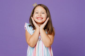 Little smiling cute pretty kid child girl 5-6 year old wears striped dress princess crown diadem hold face isolated on plain pastel light purple background. Mother's Day love family lifestyle concept