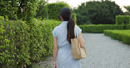 Canvas Print - Woman walk in the rose garden