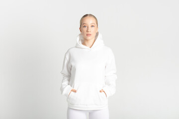 Wall Mural - Athletic woman in white hoodie and leggings. Mock-up.