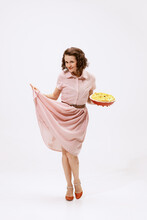 Portrait Of Beautiful Woman In Stylish Pink Dress, Holding Apple Pie Isolated Over White Background