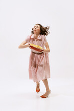 Portrait Of Emotive Woman Holding Apple Pie And Falling Down Isolated Over White Background. Funny Look