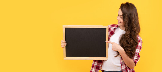 Wall Mural - happy kid presenting novelty information. childhood education. copy space for announcement. Banner of schoolgirl student. School child pupil portrait with copy space.