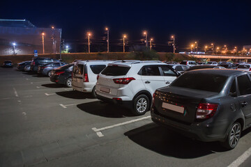 Wall Mural - cars in an illuminated parking lot