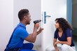 © Andrey Popov - Technician Fixing The Door Lock