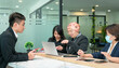© sinseeho - Group of Asian office business people working together in a modern co working space.