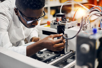 Wall Mural - african engineer programming equipment with tablet at factory