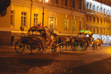 The Center Of St. Petersburg, Russia. A Horse-drawn Carriage Passes Through The Night City Of St. Petersburg, Russia.