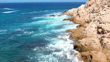 Aerial Drone Shot Of Waves Crashing On Sea Cliffs In Cabo San Lucas Mexico. Revel, Relax, Reset And Recharge In Cabo San Lucas, Baja California. Waves Crashing Into Rocky Shoreline. 4K Videos.