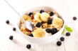 bowl with granola, milk and fresh fruits
