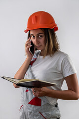 Wall Mural - beautiful female construction worker holding a folder with documents in her hands and smiling