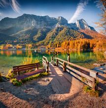 Empty Sit On The Shore Of Hintersee Lake. And Fishing Boat. Beautiful Morning View Of Bavarian Alps With Wooden Pier, Germany, Europe. Traveling Concept Background.