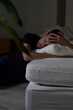 © Westend61 - Sad man with eyes closed leaning on sofa