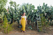 © Westend61 - Smiling farmer standing in front of prickly pear cactus a farm