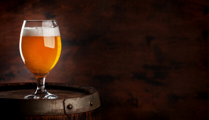 Wall Mural - Beer glass on wooden barrel