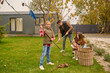 © zinkevych - Whole family cleaning their yard in autumn