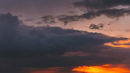 Wall Mural - 4K Sunset Cloudy Sky With Fluffy Clouds. Sunset Sky Natural Background. Dramatic Sky. Sunset Time Lapse Time-Lapse In Yellow, Orange, Pink Colors. Day To Night Transition. Cloudy Sky With Fluffy