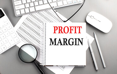 Poster - PROFIT MARGIN text on notepad on chart with keyboard and calculator on grey background