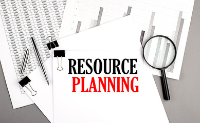 Poster - The text RESOURCE PLANNING is written on a white paper with chart. Business concept.