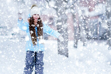 A Long-haired Little Girl Is Going To Throw A Snowball.