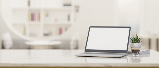Laptop mockup and copy space on modern white workspace tabletop over blurred library