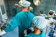 © NDABCREATIVITY - Team of surgeons in the operating room preparing for surgery