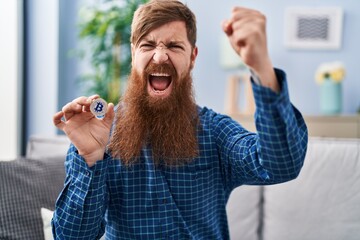 Sticker - Caucasian man with long beard holding virtual currency bitcoin annoyed and frustrated shouting with anger, yelling crazy with anger and hand raised