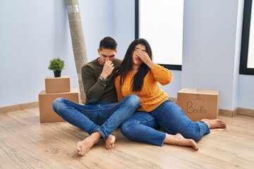 Poster - Young couple sitting on the floor at new home tired rubbing nose and eyes feeling fatigue and headache. stress and frustration concept.