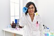 © Krakenimages.com - Young latin woman wearing scientist uniform standing at laboratory