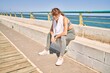 © Krakenimages.com - Young caucasian woman wearing sportswear resting at seaside