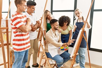 Poster - Group of people smiling happy and looking draw of partner at art studio.