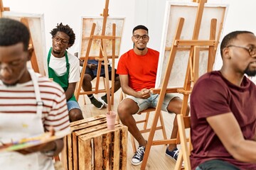 Sticker - Group of young african american artist man smiling happy drawing at art studio.