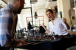 © JustLife - Colleagues having fun at work. Businessman and businesswoman playing table soccer