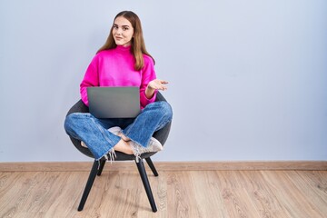 Poster - Young hispanic girl working using computer laptop pointing aside with hands open palms showing copy space, presenting advertisement smiling excited happy