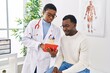 © Krakenimages.com - Man and woman doctor and patient having medical consultation using touchpad at clinic