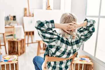 Wall Mural - Young artist student girl on back view relaxed with hands on head at art studio