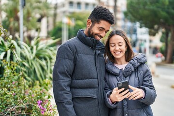 Sticker - Man and woman couple smiling confident using smartphone at park