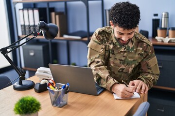 Canvas Print - Young arab man army soldier using laptop writing on notebook at office