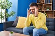 © Krakenimages.com - Young hispanic man stressed sitting on sofa at home