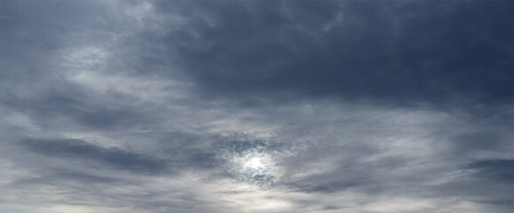 Wall Mural - panorama of sky with sun through stormy clouds