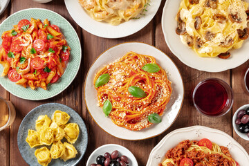 Wall Mural - Pasta, many different varieties, overhead flat lay shot. Italian food and drinks, shot from the top. Spaghetti in tomato sauce, mushroom pasta, chicken penne etc, with red wine