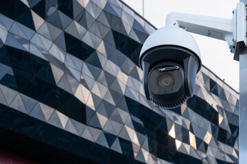Poster - Security CCTV camera in office building. Blurred background.