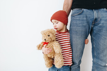 Caucasian little boy, hugging his father at home, isolated image, copy space. Family concept